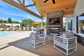 Outdoor pavilion with fireplace, flat screen tv, and food area